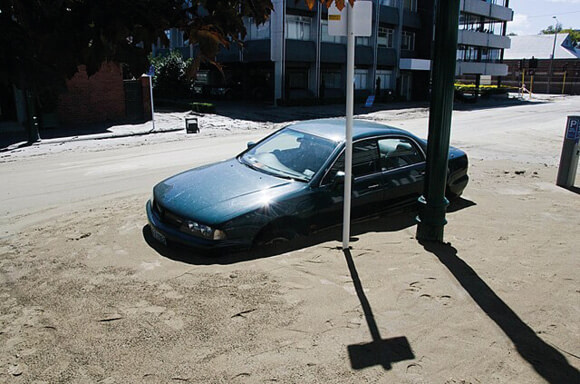 Car in liquefaction mud, Christchurch 2011